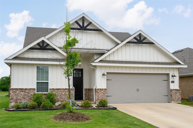 craftsman-style house with a front lawn, concrete driveway, a shingled roof, and brick siding