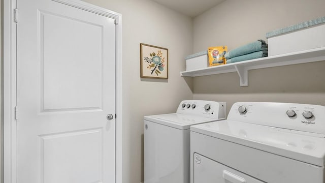 clothes washing area with washer and dryer and laundry area
