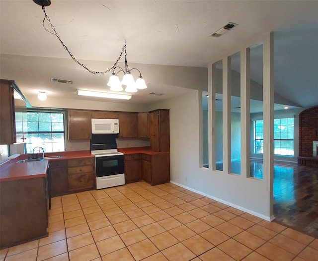 kitchen featuring a wealth of natural light, visible vents, and white appliances