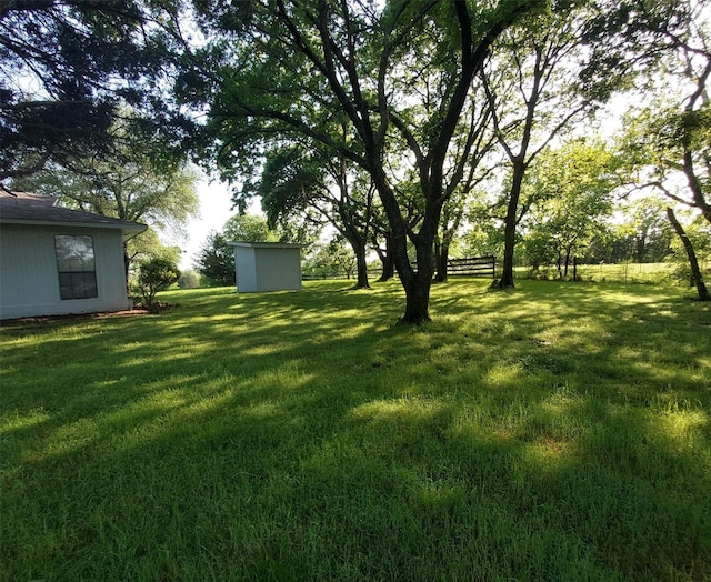 view of yard with a storage unit and an outdoor structure