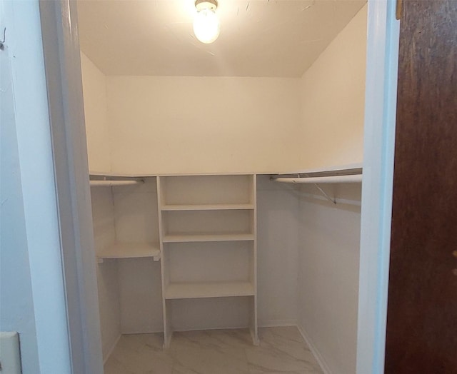 spacious closet with marble finish floor