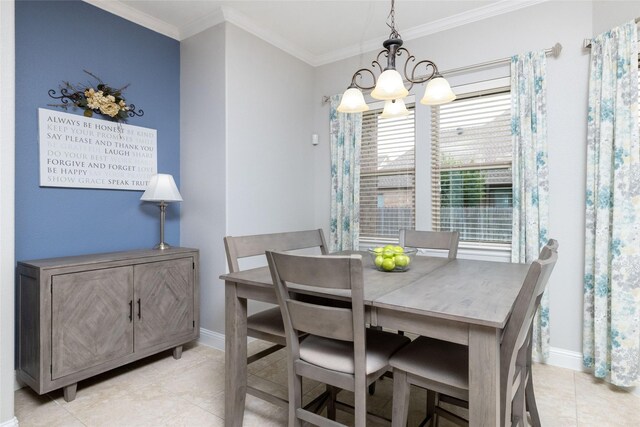dining room featuring crown molding, light tile patterned floors, a chandelier, and baseboards