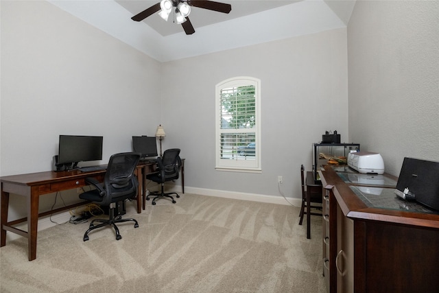 office area featuring a ceiling fan, baseboards, and light carpet