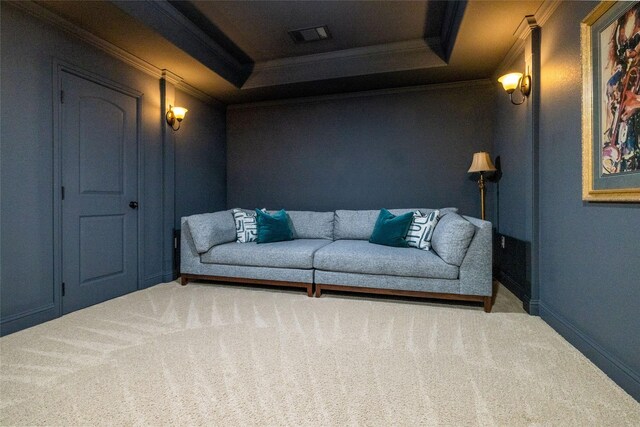 living area featuring carpet, ornamental molding, baseboards, visible vents, and a tray ceiling
