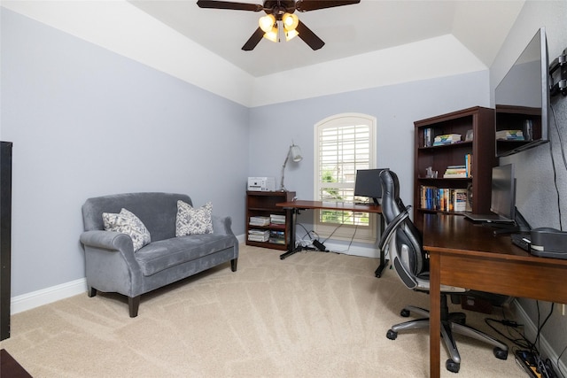 office featuring light colored carpet, ceiling fan, vaulted ceiling, and baseboards