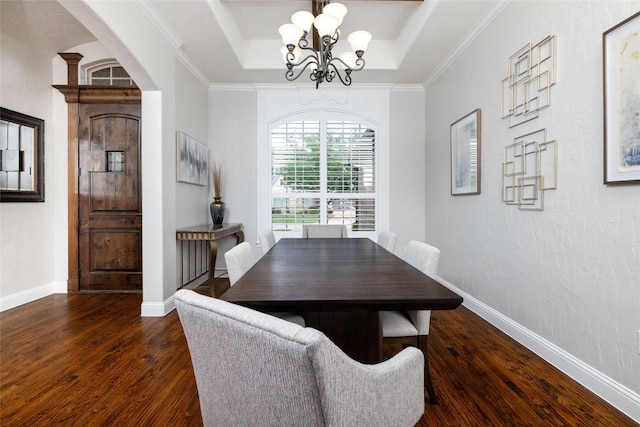 dining room featuring dark wood finished floors, baseboards, a raised ceiling, and a notable chandelier
