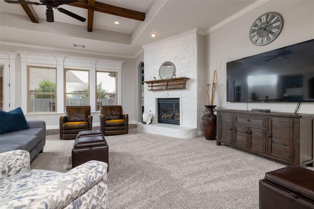 living room featuring beamed ceiling, ceiling fan, visible vents, light carpet, and a fireplace