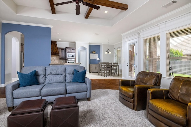 living room with visible vents, arched walkways, a ceiling fan, and wood finished floors