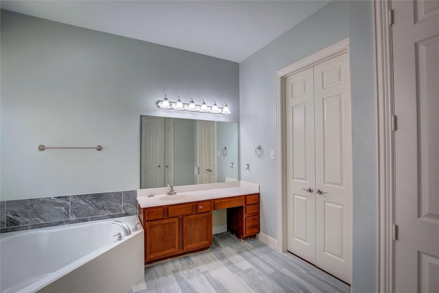 3509 New Castle Ct, Richardson, TX 75082 - bathroom featuring wood finished floors, a garden tub, and vanity