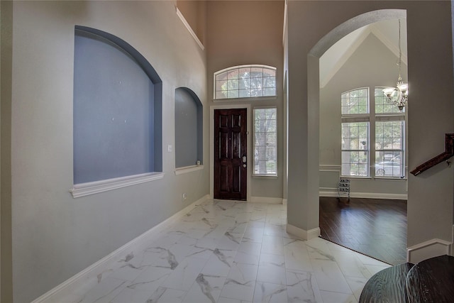 3509 New Castle Ct, Richardson, TX 75082 - foyer featuring baseboards, a notable chandelier, marble finish floor, and arched walkways