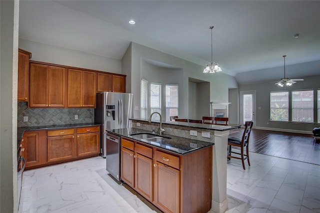 3509 New Castle Ct, Richardson, TX 75082 - kitchen featuring marble finish floor, a sink, brown cabinets, and open floor plan