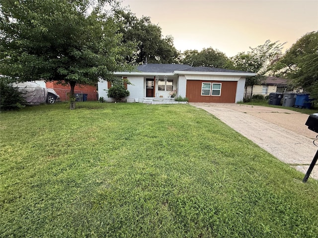 single story home featuring driveway and a front yard