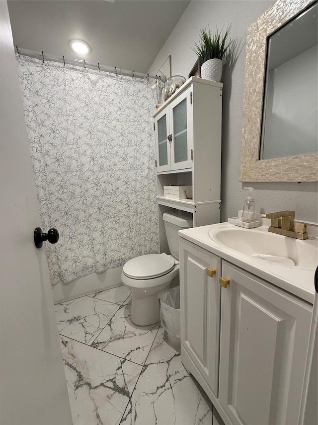 bathroom with toilet, shower / tub combo with curtain, marble finish floor, and vanity
