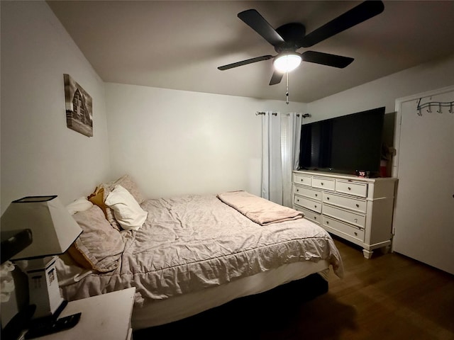 bedroom with ceiling fan and dark wood-style floors
