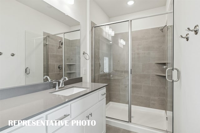 bathroom featuring recessed lighting, a shower stall, and vanity