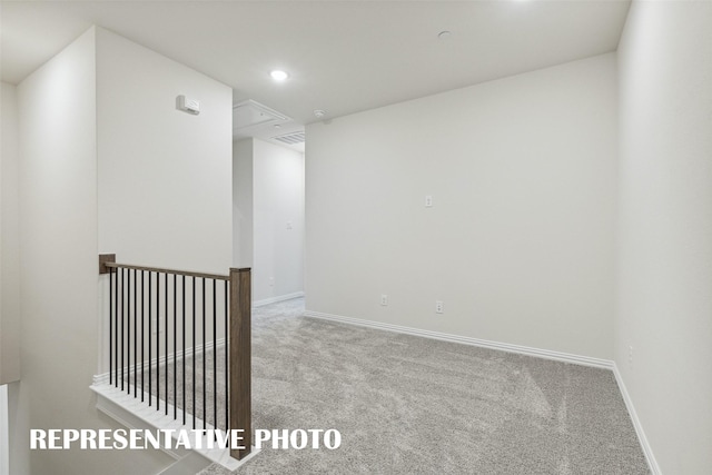 carpeted spare room with baseboards, attic access, visible vents, and recessed lighting