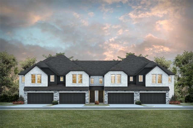 view of front of property featuring a garage, a front yard, and stone siding