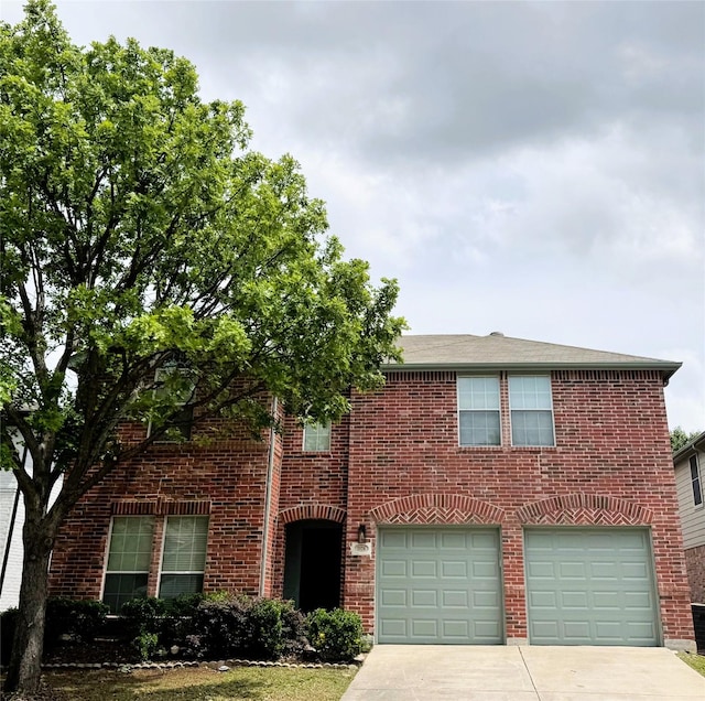 traditional home featuring brick siding, an attached garage, and concrete driveway