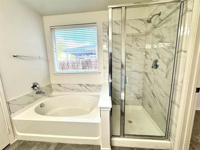 bathroom with a stall shower and a bath