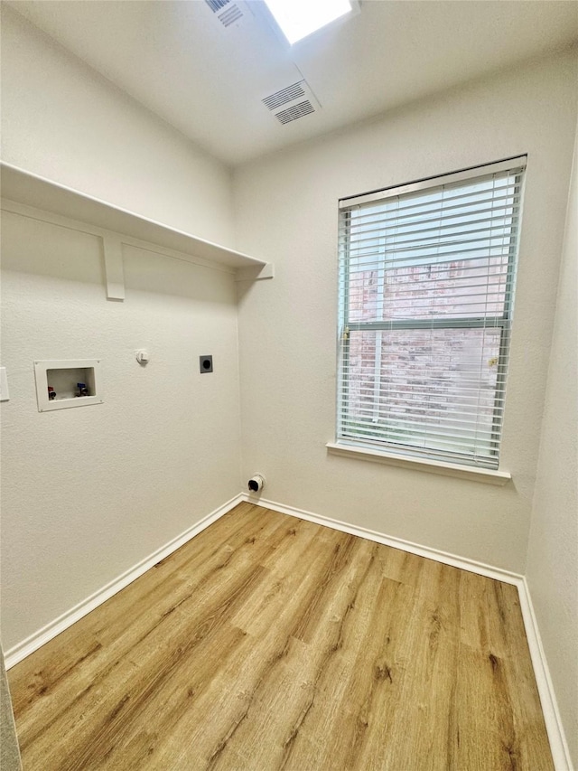 laundry room with laundry area, hookup for a washing machine, baseboards, electric dryer hookup, and wood finished floors