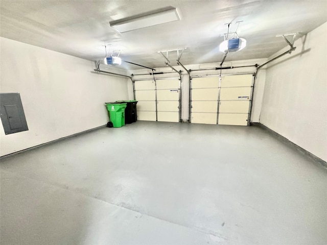 garage with a garage door opener and electric panel