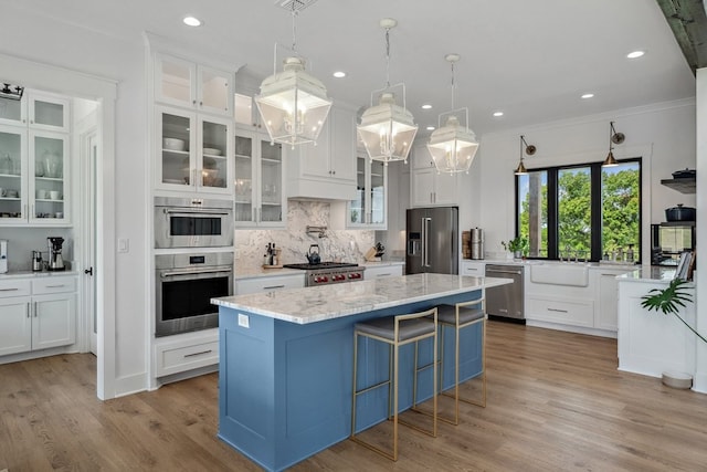 kitchen with backsplash, white cabinetry, appliances with stainless steel finishes, and plenty of natural light