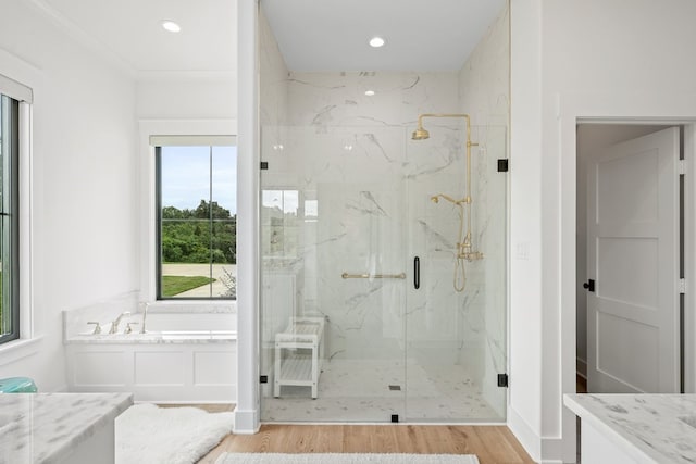 full bath featuring a garden tub, recessed lighting, a marble finish shower, and wood finished floors