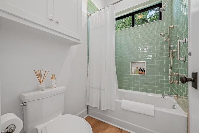 bathroom with toilet, baseboards, shower / bath combination with curtain, and wood finished floors