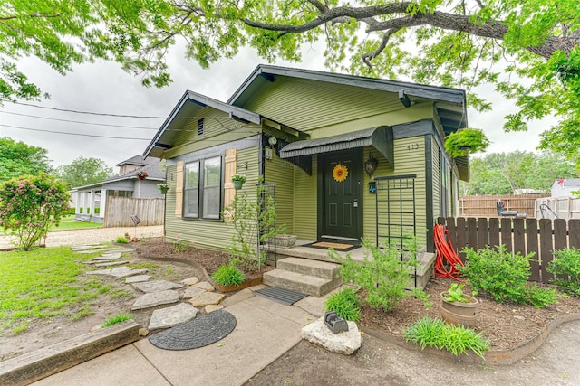 view of front of property featuring fence