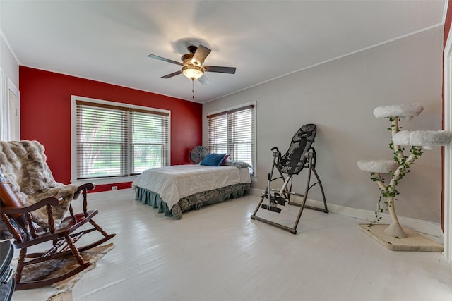 bedroom featuring a ceiling fan, baseboards, and wood finished floors
