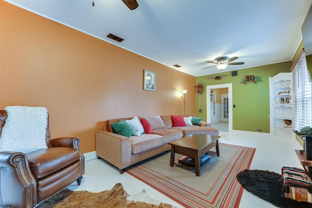 living area with a ceiling fan, baseboards, and visible vents