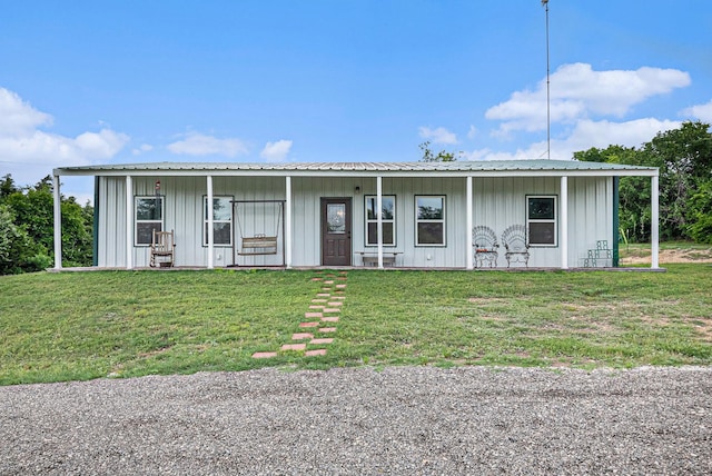 ranch-style home featuring board and batten siding and a front yard