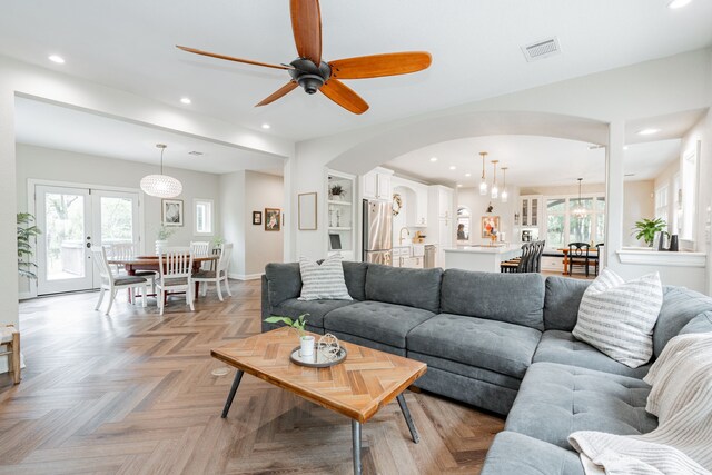 680 Alexandrite Dr, Oak Point, TX 75068 - living area featuring arched walkways, a ceiling fan, recessed lighting, and baseboards