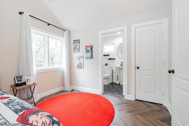 680 Alexandrite Dr, Oak Point, TX 75068 - bedroom with vaulted ceiling, baseboards, and connected bathroom