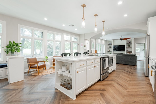 680 Alexandrite Dr, Oak Point, TX 75068 - kitchen with appliances with stainless steel finishes, arched walkways, a ceiling fan, recessed lighting, and white cabinets