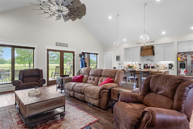 living area with recessed lighting, high vaulted ceiling, and dark wood-style floors