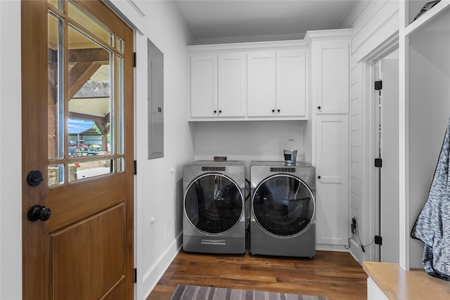 laundry room with baseboards, dark wood finished floors, electric panel, washing machine and clothes dryer, and cabinet space