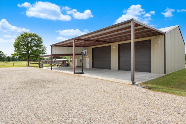exterior space with a garage, fence, and an outdoor structure