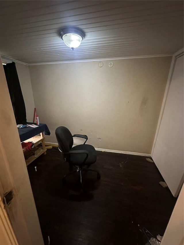 interior space with baseboards, ornamental molding, and wood finished floors