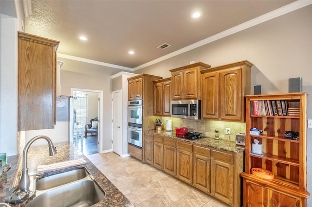 102 Wait Station Ave, Tuscola, TX 79562 - kitchen featuring a sink, appliances with stainless steel finishes, ornamental molding, decorative backsplash, and light stone countertops