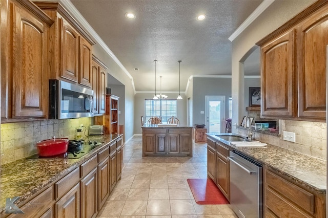 102 Wait Station Ave, Tuscola, TX 79562 - kitchen with appliances with stainless steel finishes, a sink, crown molding, backsplash, and brown cabinets
