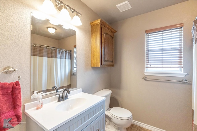 102 Wait Station Ave, Tuscola, TX 79562 - bathroom with toilet, vanity, a textured wall, and baseboards