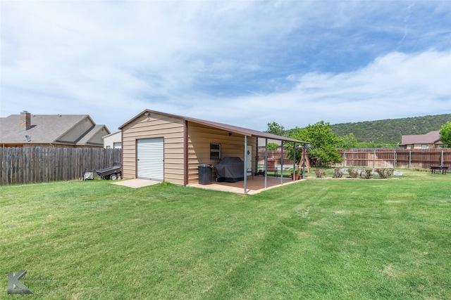 102 Wait Station Ave, Tuscola, TX 79562 - view of yard with a garage, an outdoor structure, and a patio area