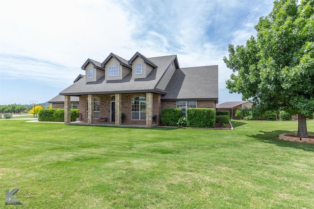 102 Wait Station Ave, Tuscola, TX 79562 - cape cod home with a front lawn, a shingled roof, brick siding, and covered porch