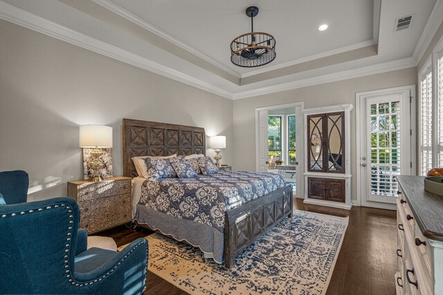 bedroom featuring a notable chandelier, access to exterior, a tray ceiling, visible vents, and dark wood-style floors