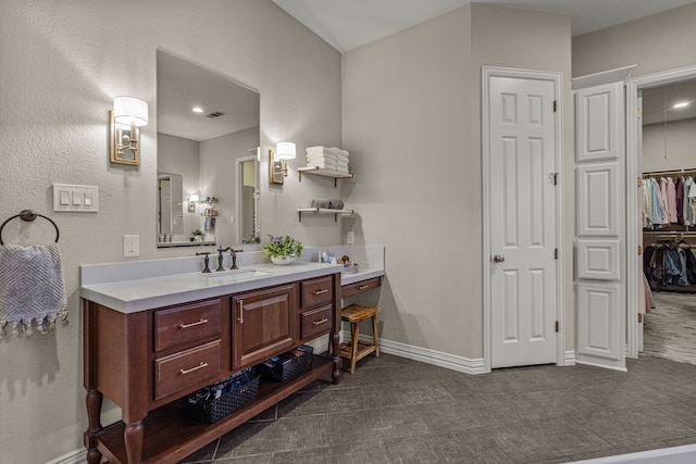 bathroom with vanity, baseboards, and visible vents