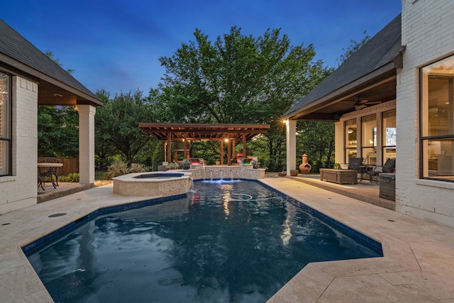 view of pool featuring a ceiling fan, a pergola, a pool with connected hot tub, and a patio area