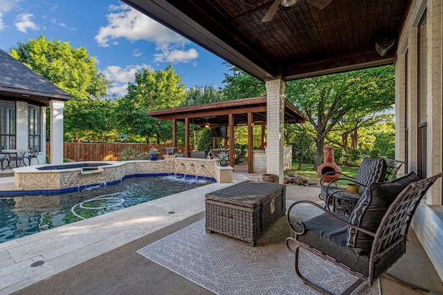 view of patio featuring an in ground hot tub, a fenced in pool, a ceiling fan, and a fenced backyard