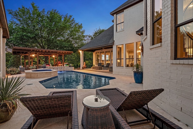 outdoor pool with an outdoor hangout area, an in ground hot tub, and a patio area