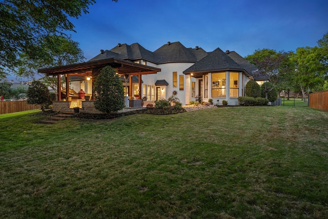 back of property with a yard, fence, and cooling unit